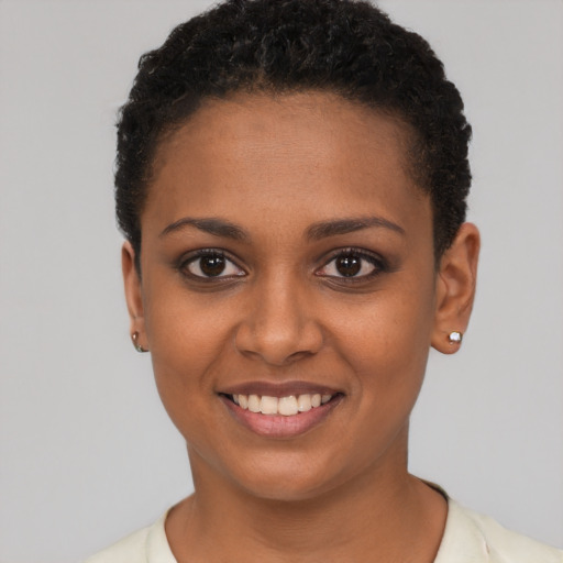 Joyful black young-adult female with short  brown hair and brown eyes