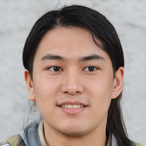 Joyful asian young-adult male with medium  brown hair and brown eyes