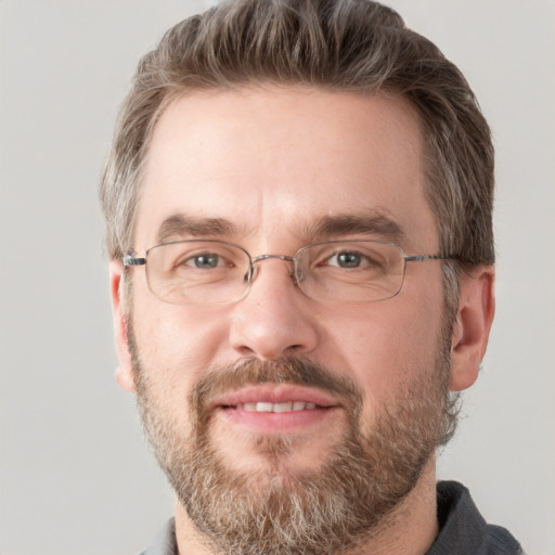 Joyful white adult male with short  brown hair and grey eyes