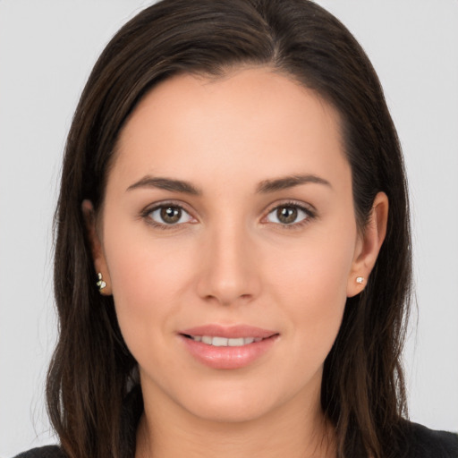 Joyful white young-adult female with long  brown hair and brown eyes