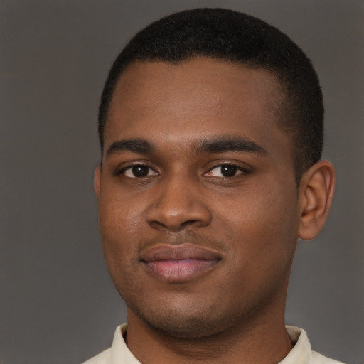 Joyful latino young-adult male with short  brown hair and brown eyes
