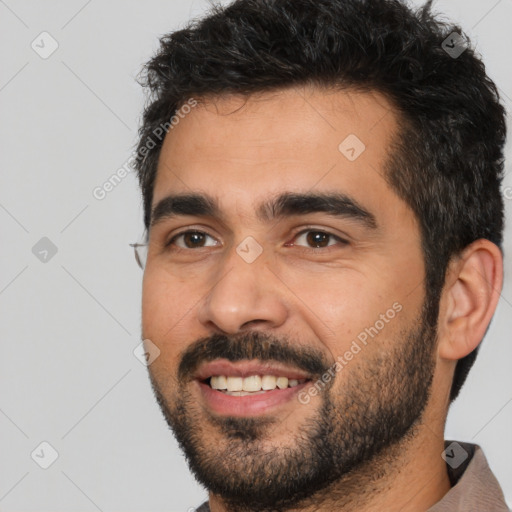 Joyful white young-adult male with short  black hair and brown eyes