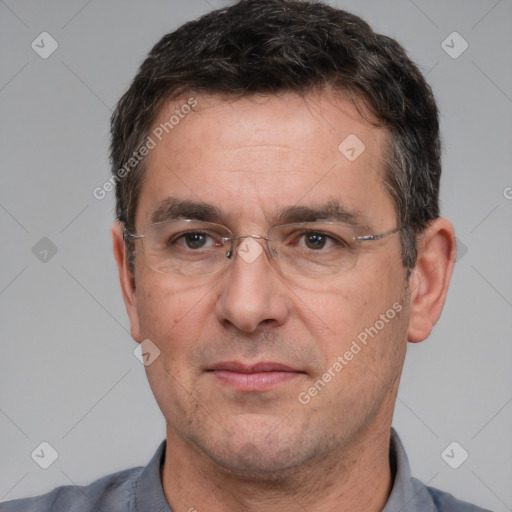 Joyful white adult male with short  black hair and brown eyes