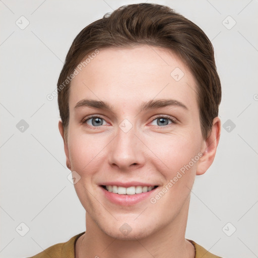 Joyful white young-adult female with short  brown hair and grey eyes