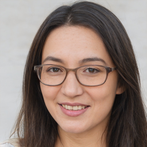 Joyful white adult female with long  brown hair and brown eyes