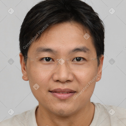 Joyful asian adult male with short  brown hair and brown eyes