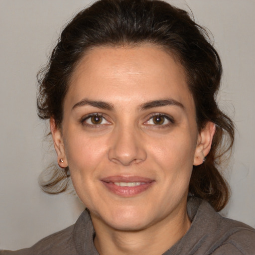 Joyful white adult female with medium  brown hair and brown eyes