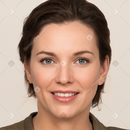 Joyful white young-adult female with medium  brown hair and grey eyes