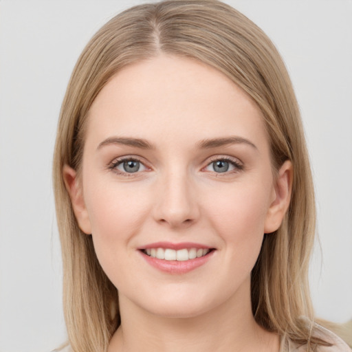 Joyful white young-adult female with long  brown hair and grey eyes