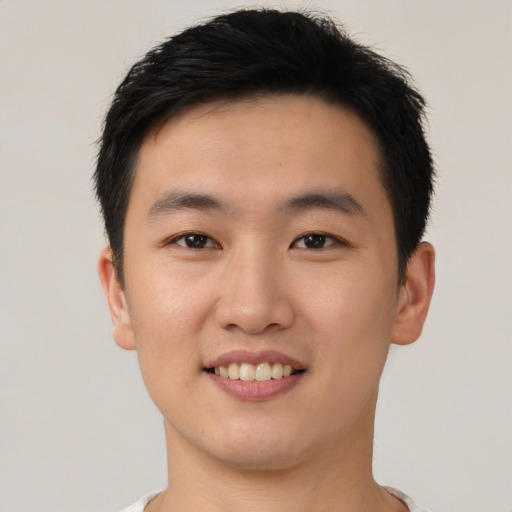 Joyful asian young-adult male with short  black hair and brown eyes