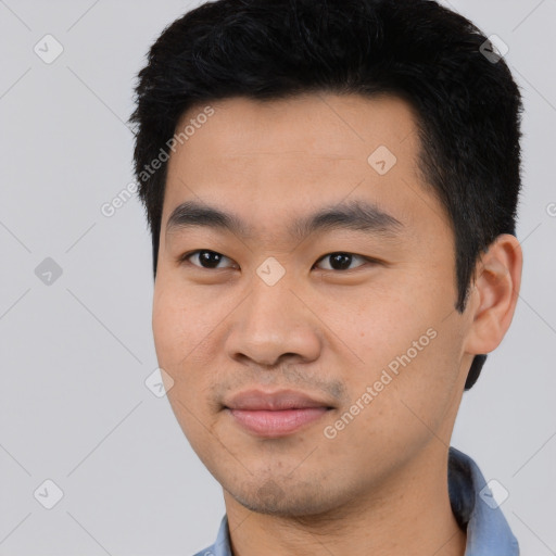 Joyful asian young-adult male with short  black hair and brown eyes