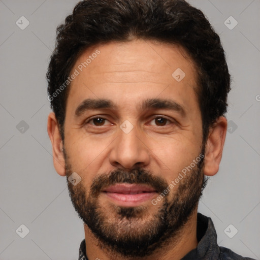 Joyful white adult male with short  black hair and brown eyes