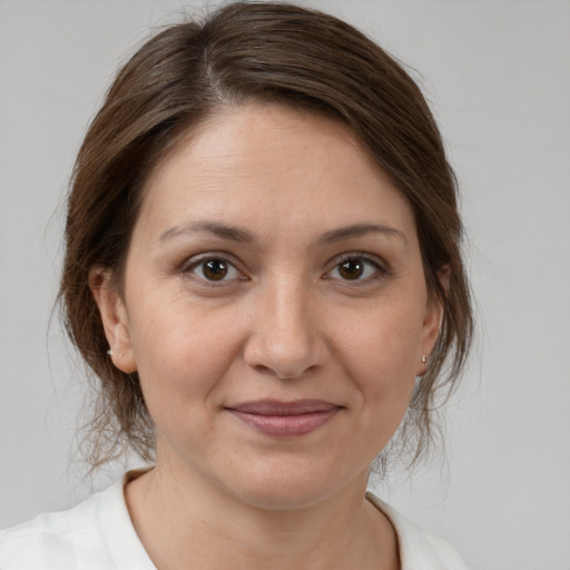 Joyful white adult female with medium  brown hair and brown eyes