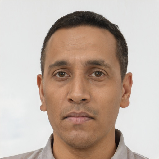 Neutral latino adult male with short  black hair and brown eyes