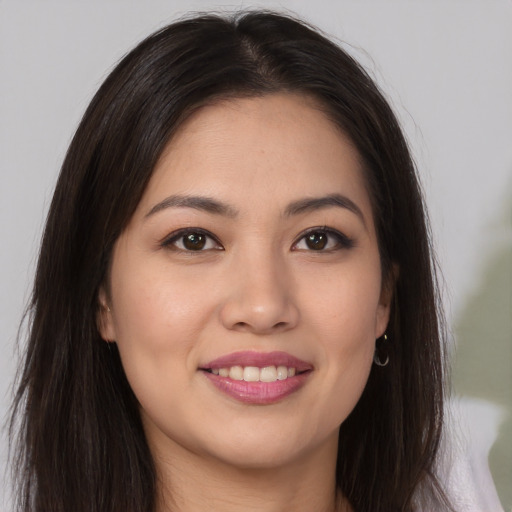 Joyful asian young-adult female with long  brown hair and brown eyes