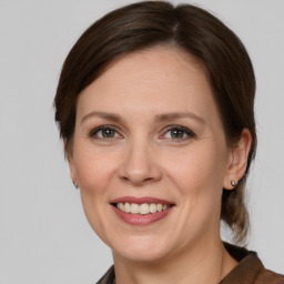 Joyful white adult female with medium  brown hair and grey eyes