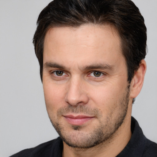 Joyful white young-adult male with short  brown hair and brown eyes