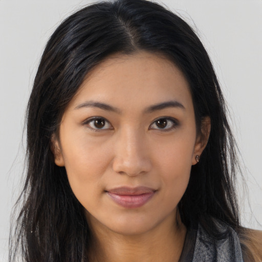 Joyful latino young-adult female with long  brown hair and brown eyes