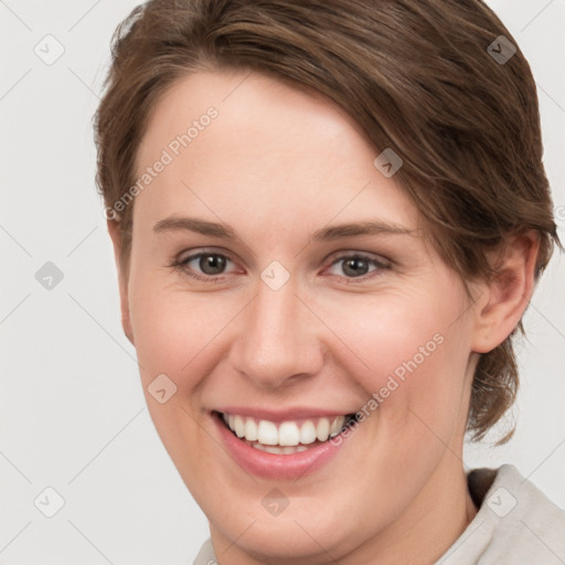 Joyful white young-adult female with short  brown hair and grey eyes