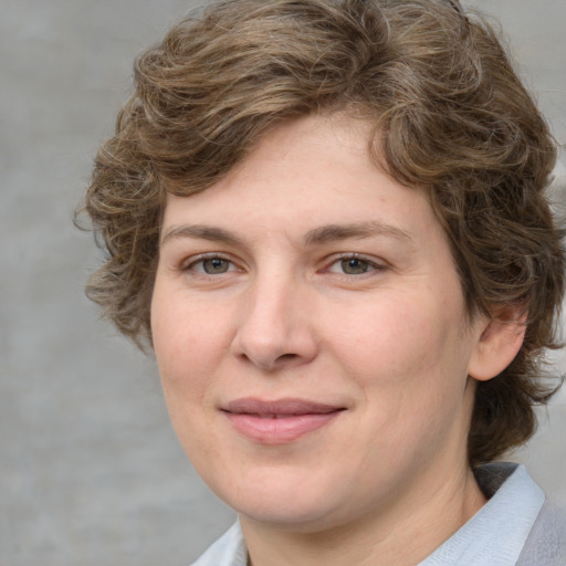 Joyful white young-adult female with medium  brown hair and green eyes