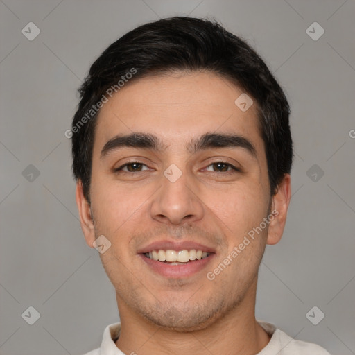 Joyful white young-adult male with short  black hair and brown eyes