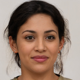 Joyful latino young-adult female with medium  brown hair and brown eyes