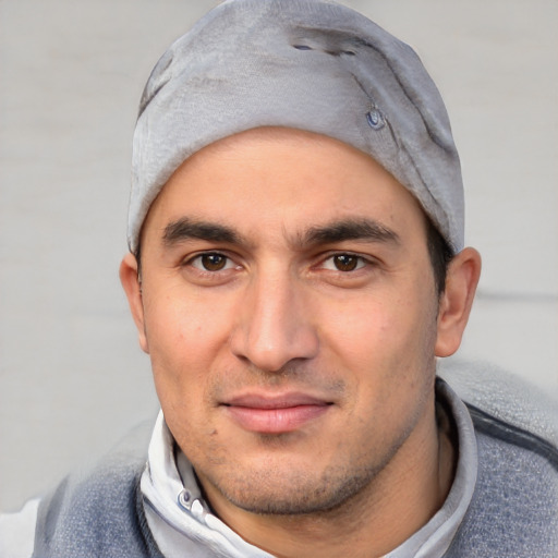 Joyful white young-adult male with short  black hair and brown eyes