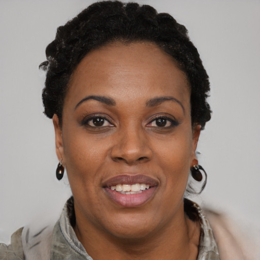 Joyful black adult female with short  brown hair and brown eyes