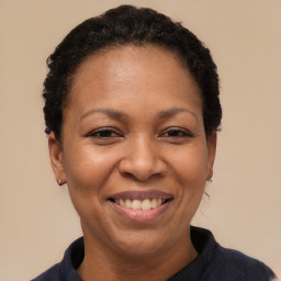 Joyful black adult female with short  brown hair and brown eyes