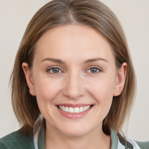 Joyful white young-adult female with medium  brown hair and grey eyes