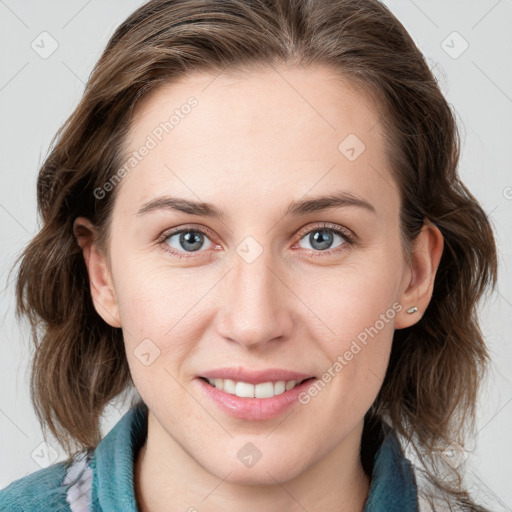 Joyful white young-adult female with medium  brown hair and blue eyes