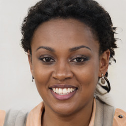 Joyful black young-adult female with long  brown hair and brown eyes