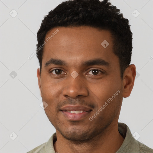 Joyful black young-adult male with short  black hair and brown eyes