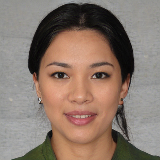 Joyful asian young-adult female with medium  black hair and brown eyes