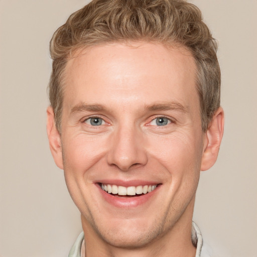 Joyful white adult male with short  brown hair and grey eyes