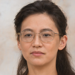 Joyful white adult female with long  brown hair and brown eyes