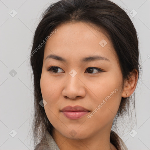 Joyful asian young-adult female with long  brown hair and brown eyes