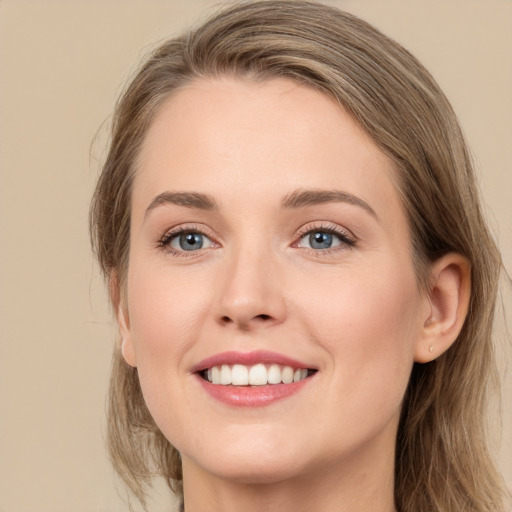 Joyful white young-adult female with long  brown hair and grey eyes