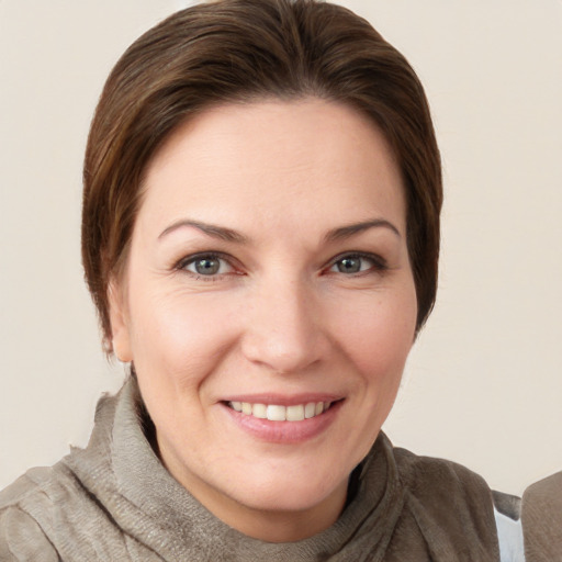 Joyful white young-adult female with short  brown hair and grey eyes