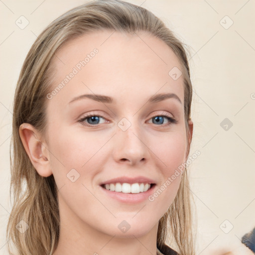 Joyful white young-adult female with long  brown hair and blue eyes