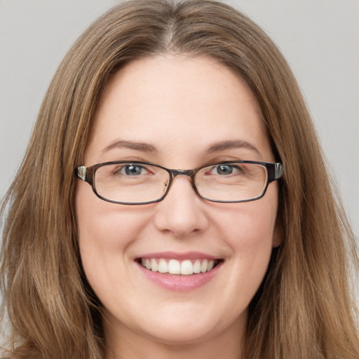 Joyful white young-adult female with long  brown hair and green eyes