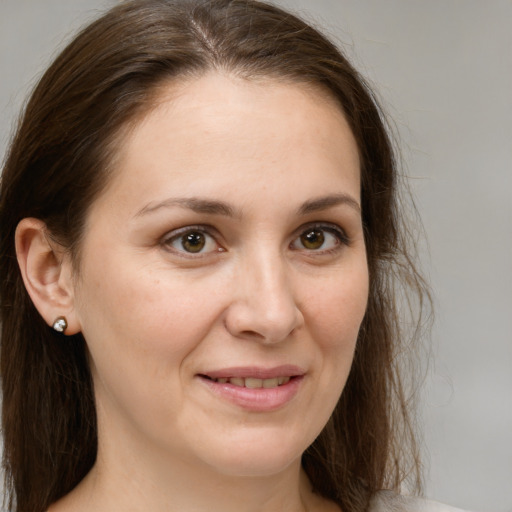 Joyful white young-adult female with medium  brown hair and brown eyes