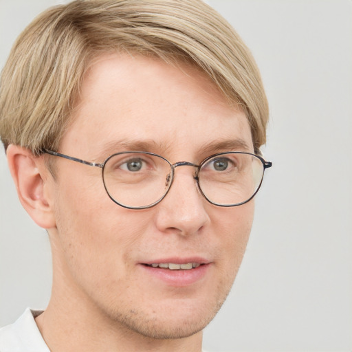 Joyful white adult male with short  brown hair and blue eyes