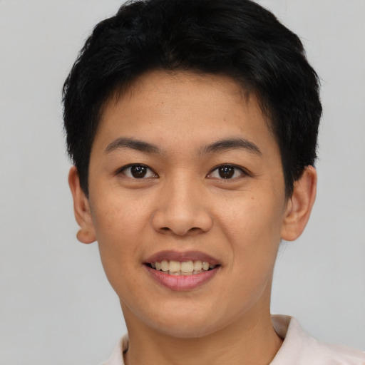 Joyful asian young-adult female with short  black hair and brown eyes