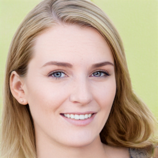 Joyful white young-adult female with long  brown hair and blue eyes