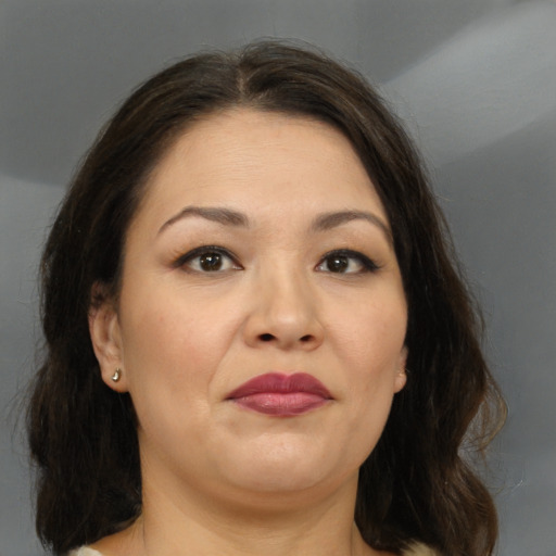Joyful white adult female with medium  brown hair and brown eyes