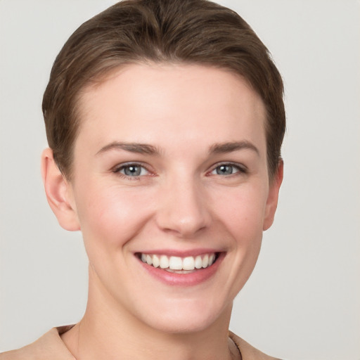 Joyful white young-adult female with short  brown hair and grey eyes