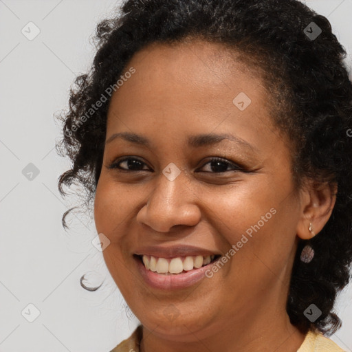 Joyful black young-adult female with medium  brown hair and brown eyes