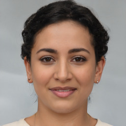 Joyful latino young-adult female with medium  brown hair and brown eyes