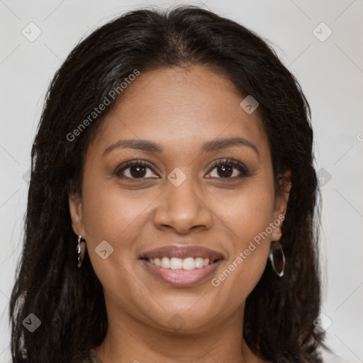 Joyful black young-adult female with long  brown hair and brown eyes